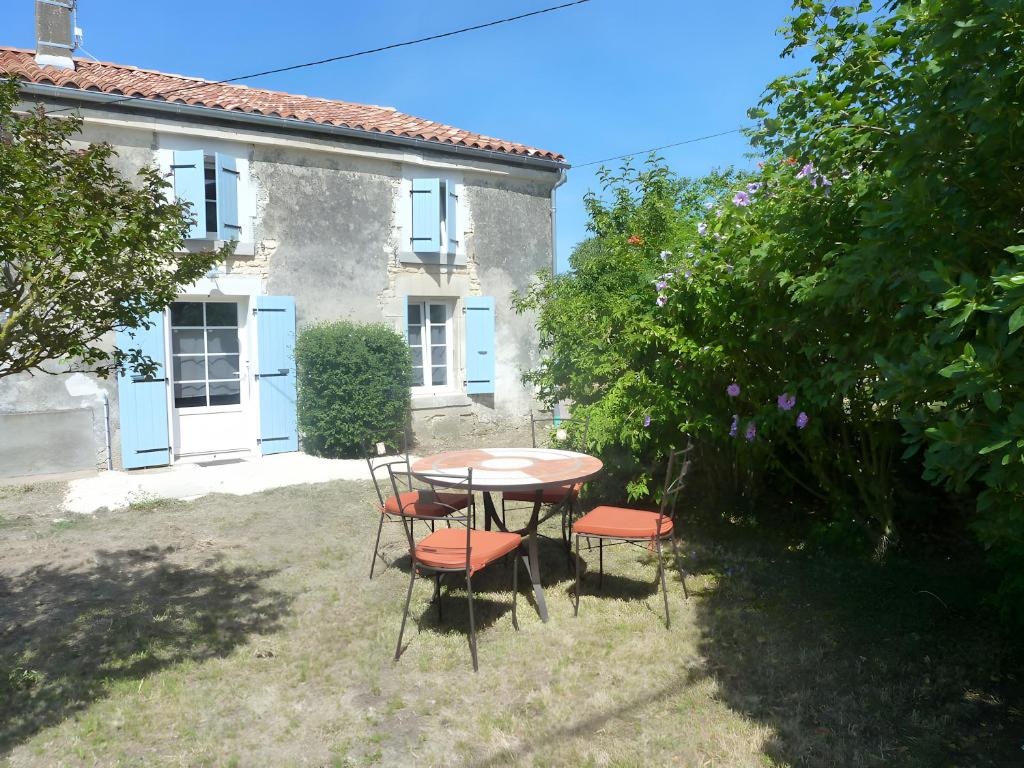 a table and chairs in front of a house at Gîte Du Maroye in Montreuil