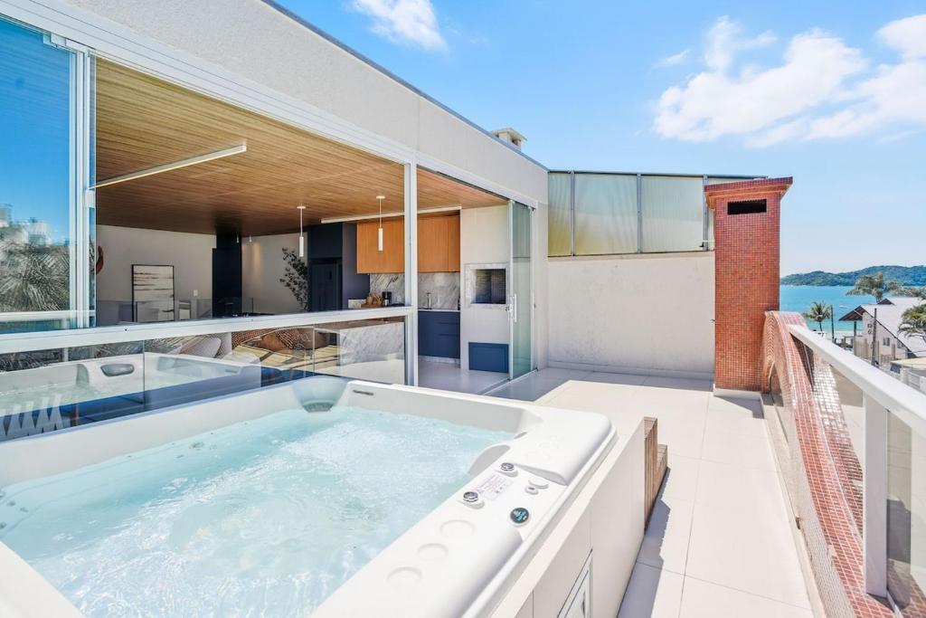 an indoor hot tub on the balcony of a house at Cobertura Duplex Vista Mar - Ofurô - 4 suítes in Bombinhas