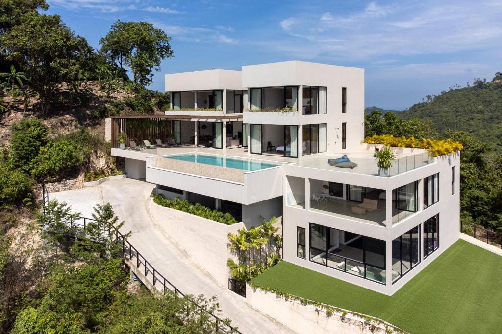 an aerial view of a white house with a swimming pool at Sea Breeze Villa in Amphoe Koh Samui