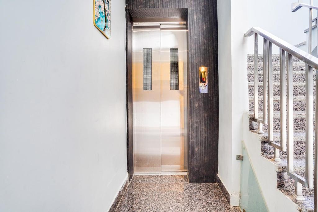 a hallway with a door leading to a stairway at Super Collection O Panchvati Regency in Bhopal