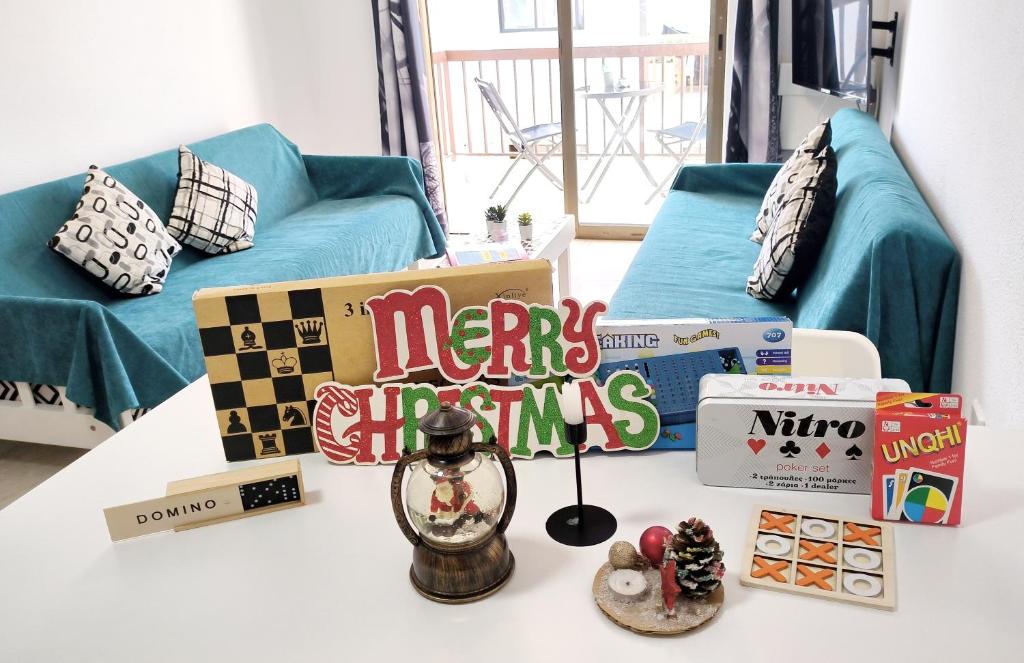 een woonkamer met een tafel met cadeaus en een bank bij CHRISTMAS OFFER -70 Percent OFF - Sleep 5 - Best Location - Free Parking in Ayia Napa