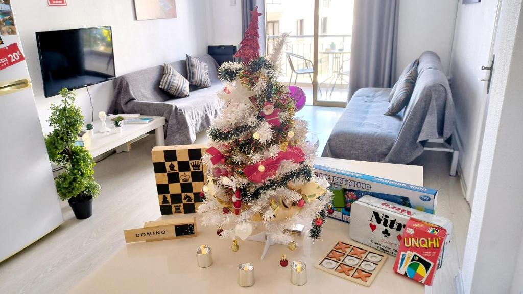 a living room with a christmas tree on the floor at CHRISTMAS OFFER -70 Percent OFF - 2 BR - Sleep 7 - Best Location at Ayia Napa City Center in Ayia Napa