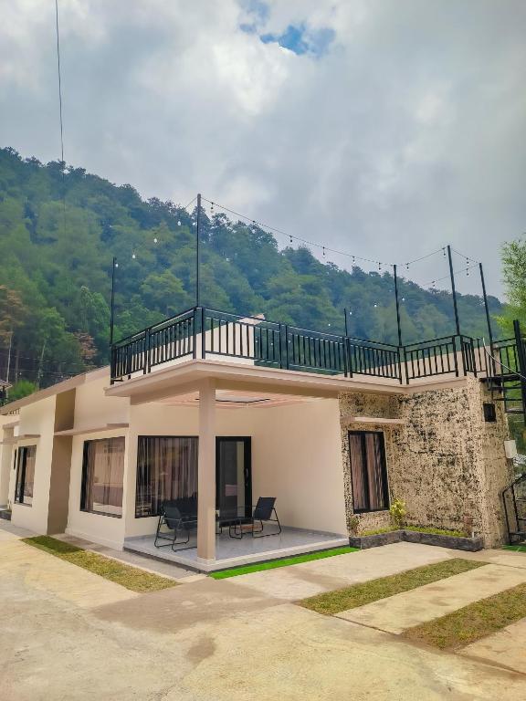 un bâtiment avec un balcon au-dessus dans l'établissement Villa nuansa tawangmangu, à Tawangmangu
