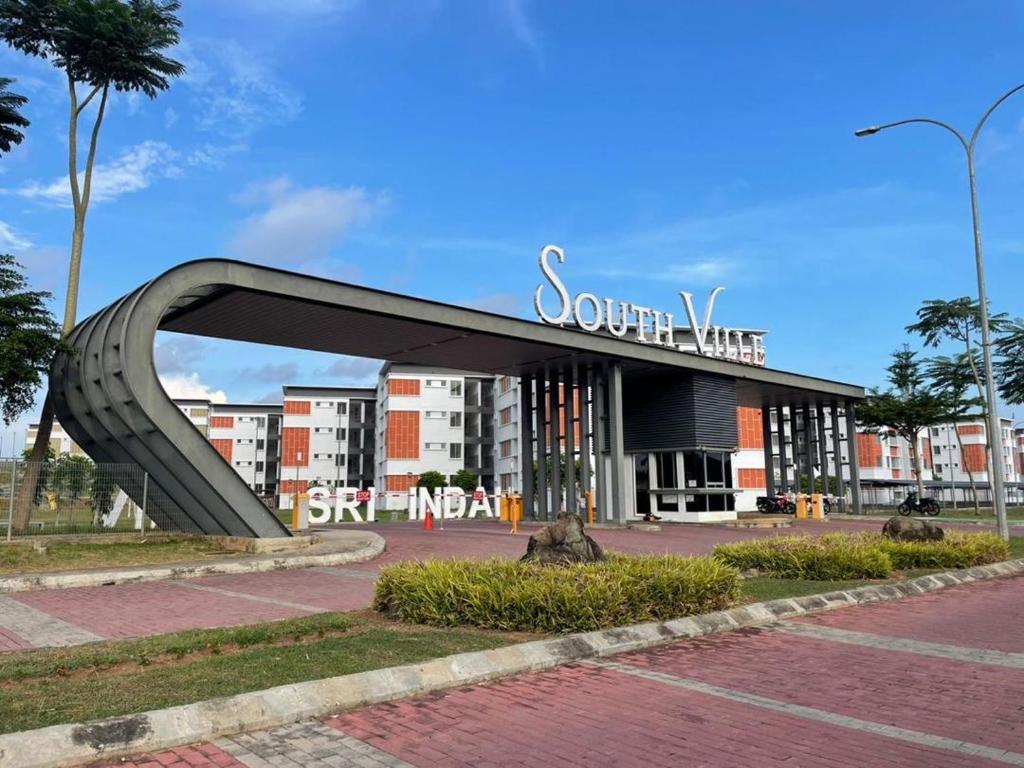 a sculpture in front of a building with a sign at Ayana Homestay in Tawau