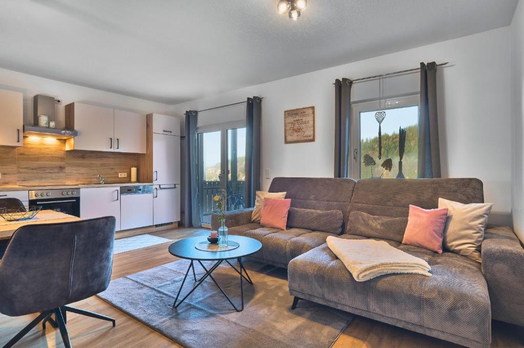 a living room with a couch and a table at Ferienwohnungen Geiger in Bodenmais