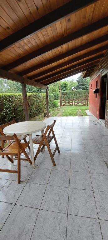 a picnic table and bench on a patio at Posta Magica in Villa Ciudad Parque