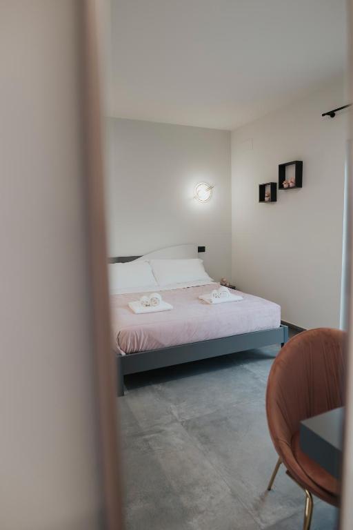 a bedroom with a bed and a table and a chair at B&B Lilà in Chieti