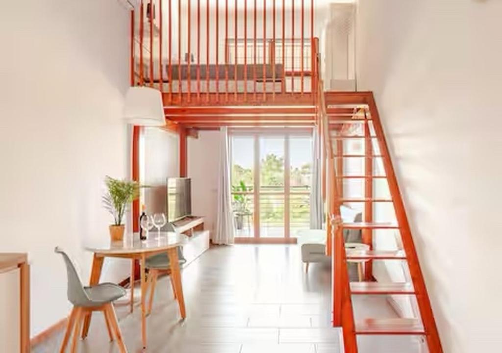 a living room with a loft bed and a table at Alba Sea 27 in Casal Palocco