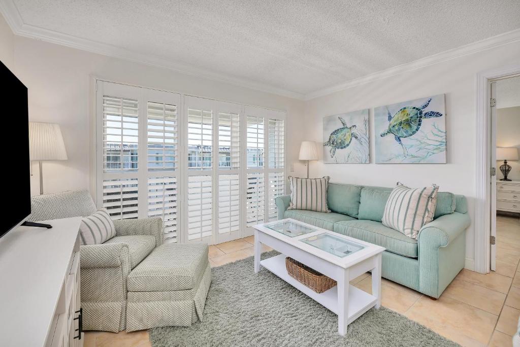 a living room with a couch and a table at Beach Club #414 in Saint Simons Island