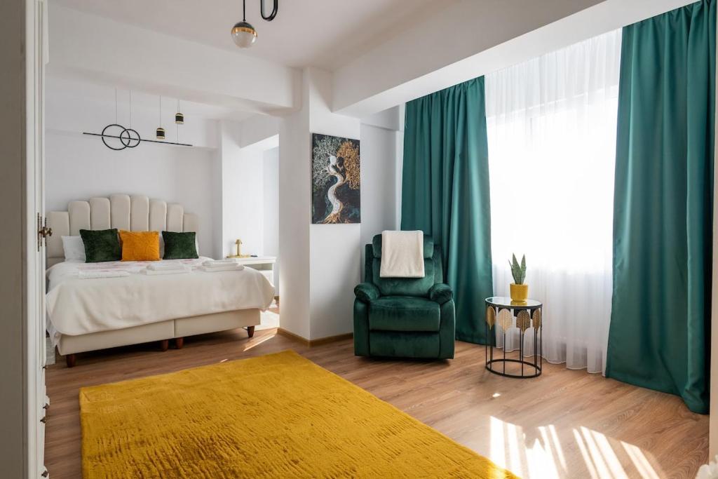 a bedroom with a bed and a green chair at Apartament de închiriat Accommodation nr 10 in Suceava