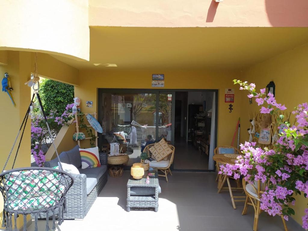 a patio with chairs and tables and flowers at Rony by Best Holidays Fuerteventura in Corralejo