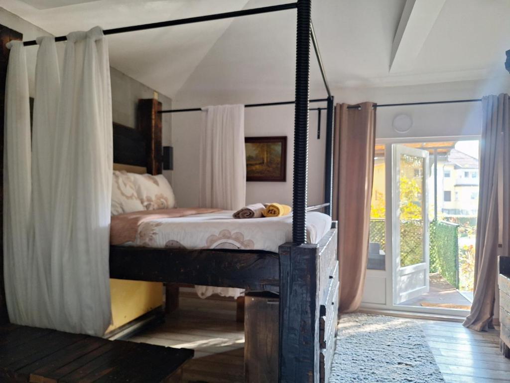 a bedroom with a canopy bed in a room at Apartment Mia in Vrnjačka Banja