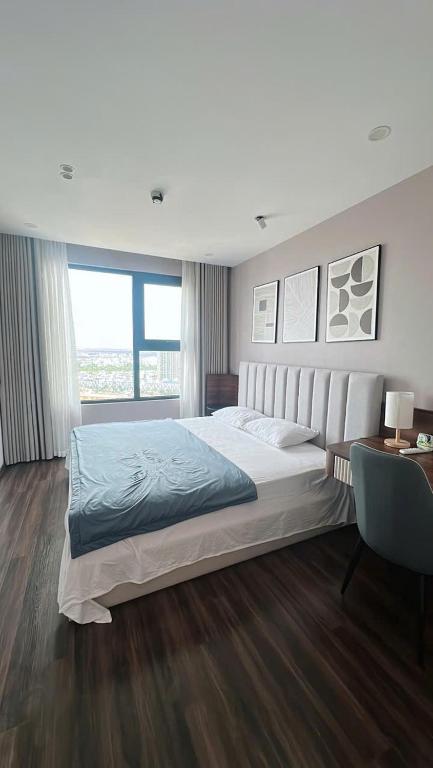 a large bedroom with a large bed and a desk at Sunmie Home Hoàng Huy Commerce Apartment in Hai Phong