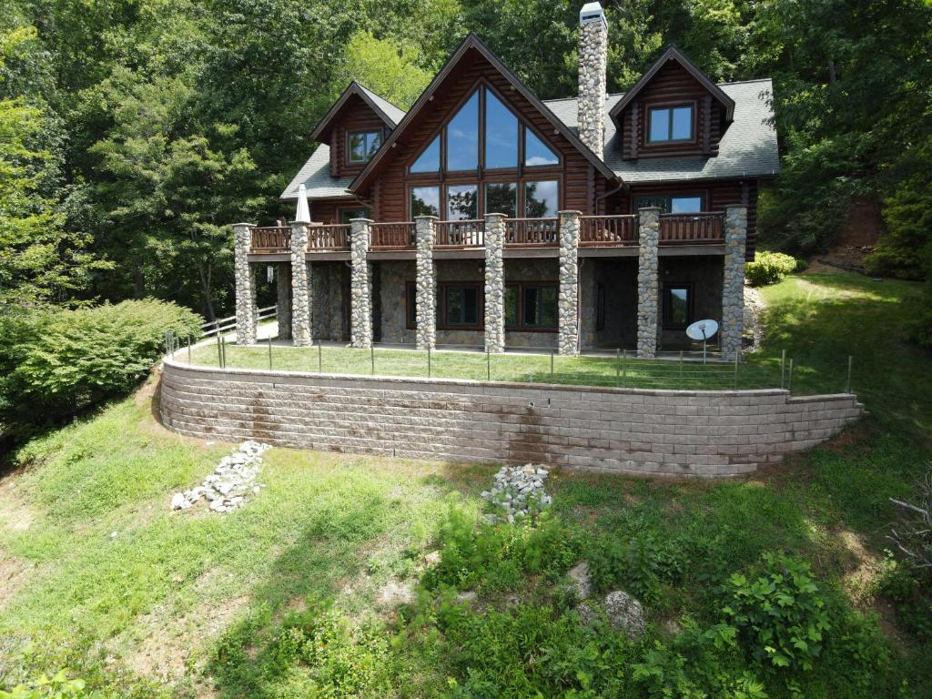 a house on a hill with a brick wall at Good Day Sunshine in Lenoir