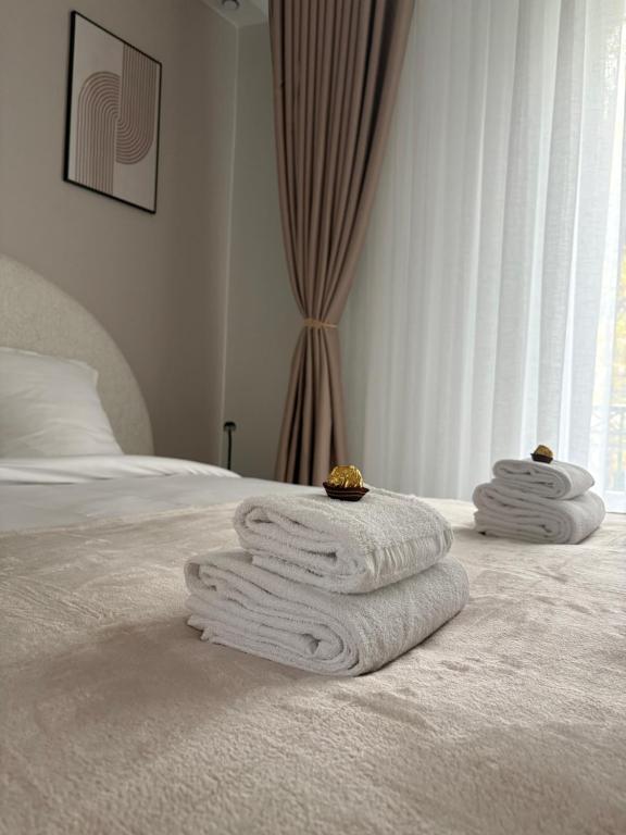 a pile of towels sitting on top of a bed at Hôtel Sofiane in Paris