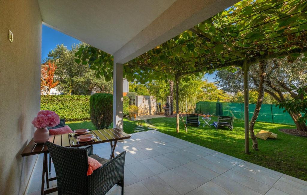 a patio with a table and chairs and a yard at Villa Mir - Rovinj by Villas Guide in Štanga