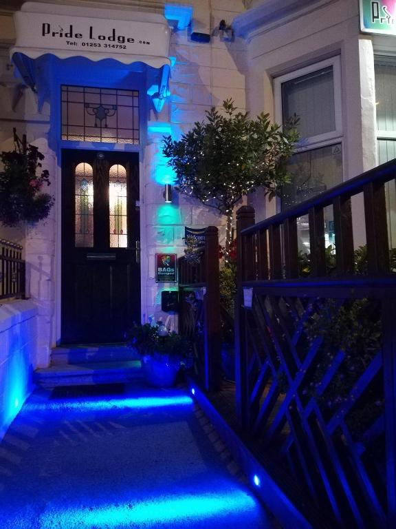 a house with blue lights on the front door at Pride Lodge in Blackpool