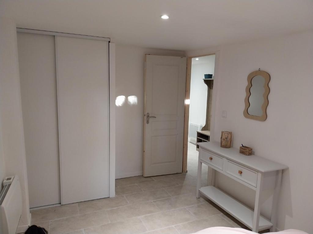 a white room with a closet and a door at Les aires in Tourbes
