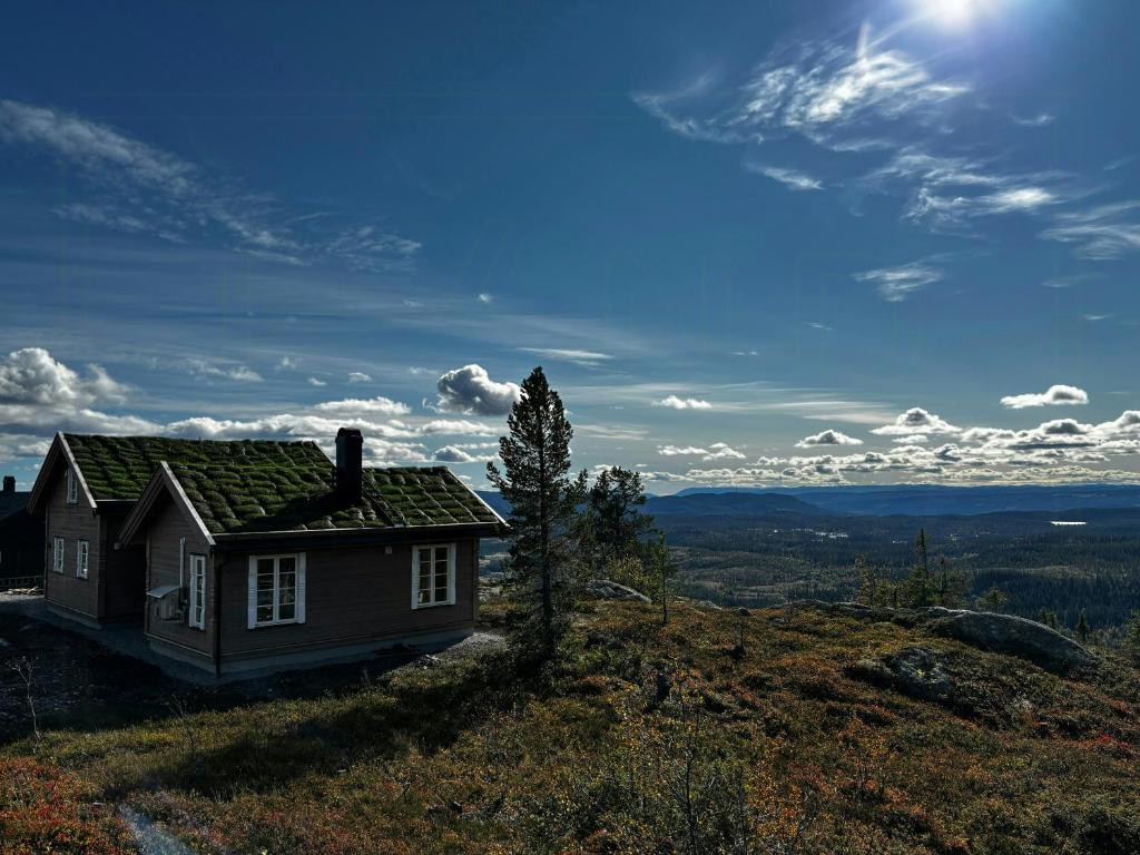 a small house sitting on top of a hill at Mountain Cabin With Panoramic Views In Valdres in Bruflat