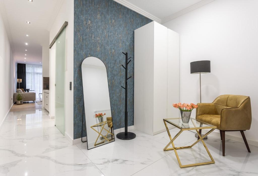 a living room with a chair and a table at Ferienwohnung Salinenparc Design Budget Hotel in Erwitte