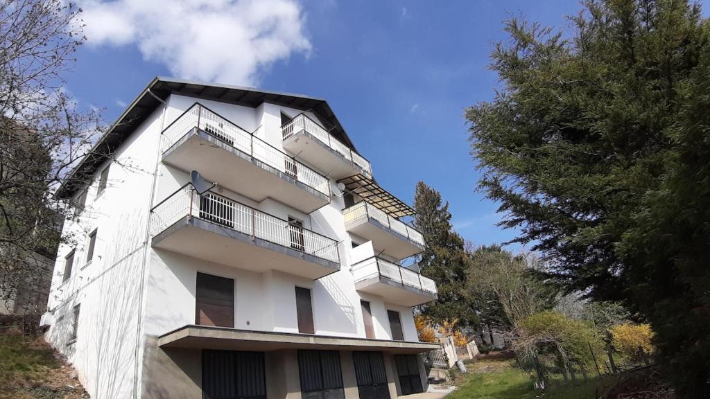 a white building with balconies on the side of it at La Maison d'la Brumatera , ALLOGGIO CON 2 CAMERE DA LETTO E VISTA in Rubiana