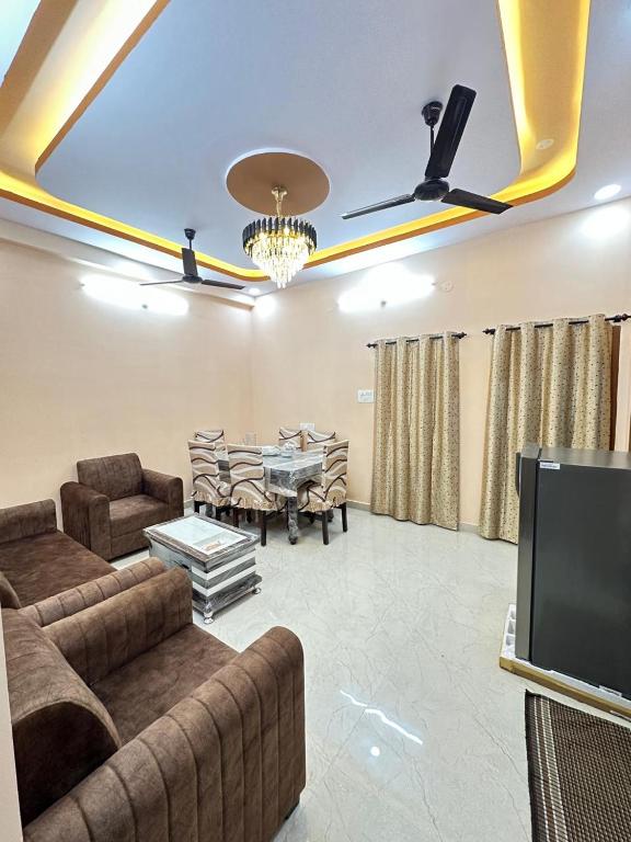 a living room with a couch and a dining room at Ahmed's Guest House in Hyderabad
