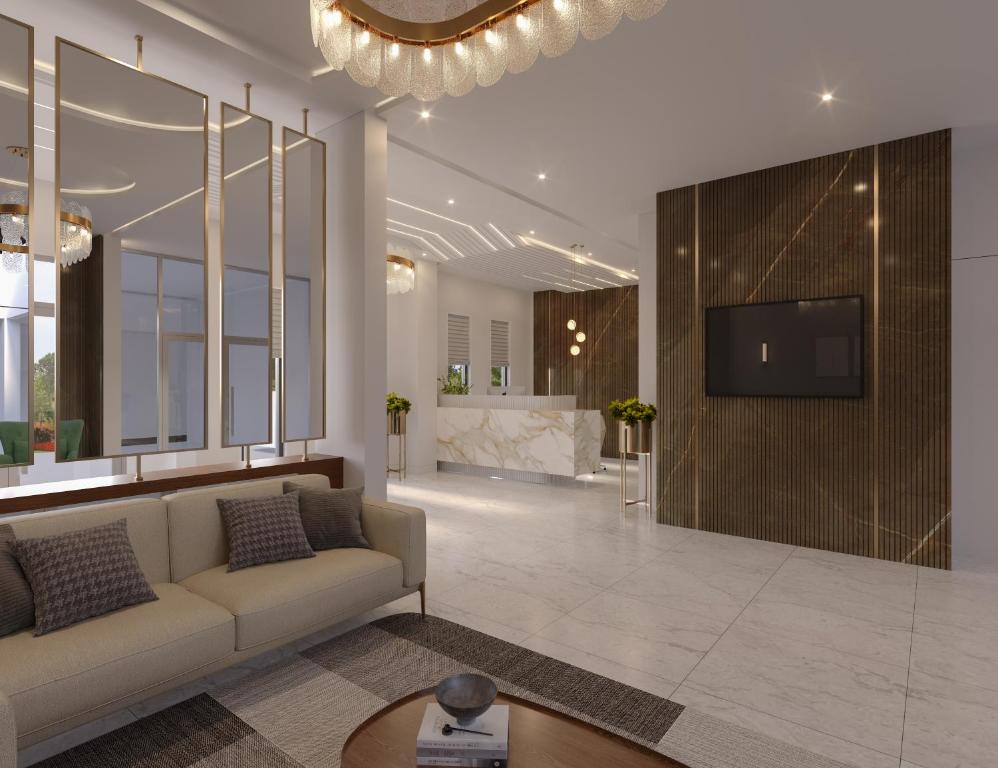 ein Wohnzimmer mit Couch und Flachbildfernseher in der Unterkunft Majestic Manor Hotel Apartment Dakar Diamniadio in Rufisque