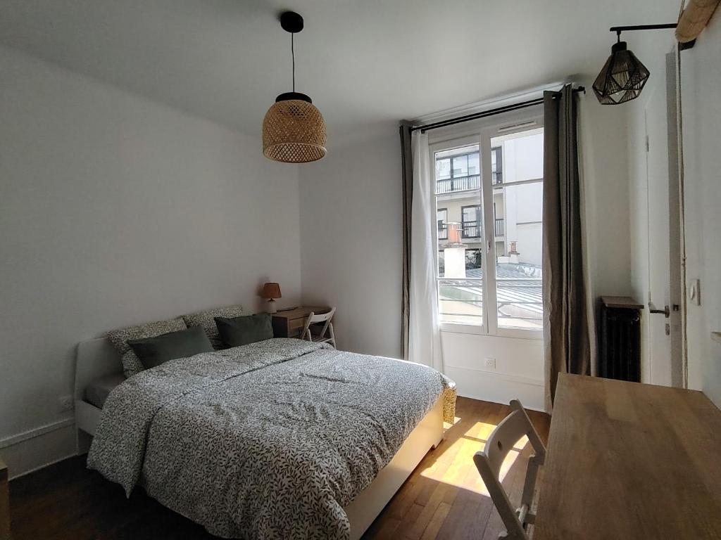 Postel nebo postele na pokoji v ubytování TOUR EIFFEL Paris