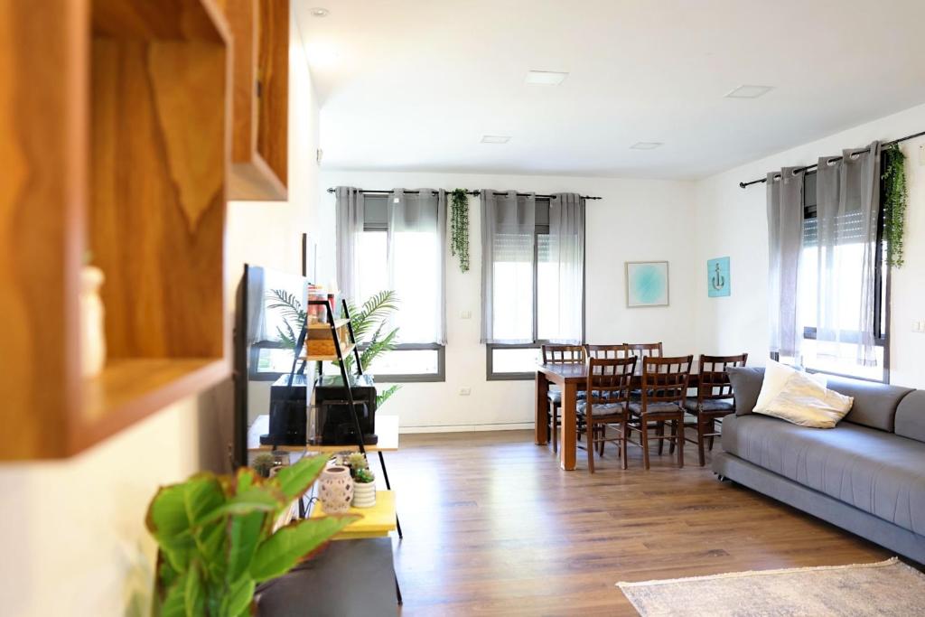 a living room with a couch and a table at Suite Golan in Neot Golan