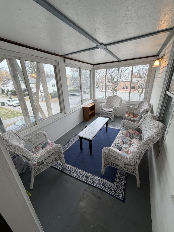 a screened in porch with chairs and a table at The Coastal Connection in South Portland