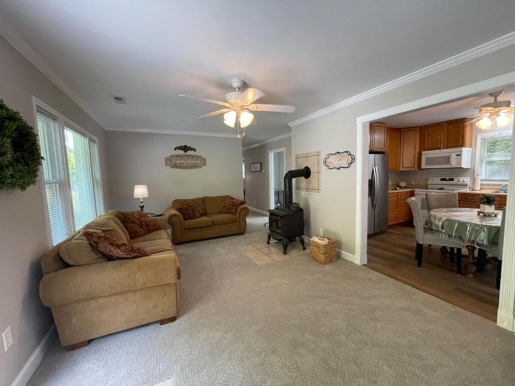 a living room with a couch and a dining room at Deer Run Creek Cottage in Mountain City