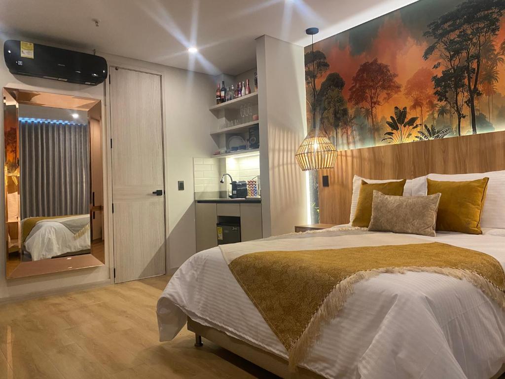 a bedroom with a large bed with a large painting on the wall at Hotel Ryo 74b Piso 7 Vip in Medellín