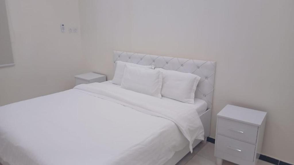 Postel nebo postele na pokoji v ubytování سويت اليمامه للشقق المخدومه