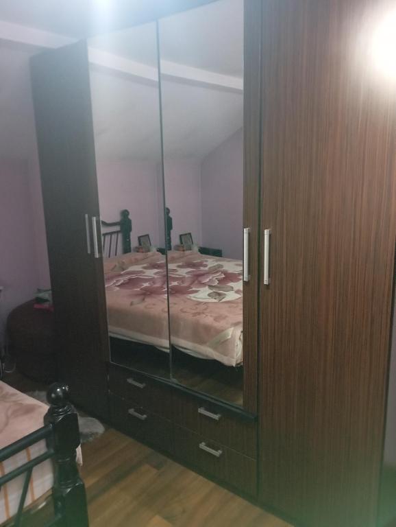 une chambre avec un lit dans un grand miroir dans l'établissement Mircea, à Craiova