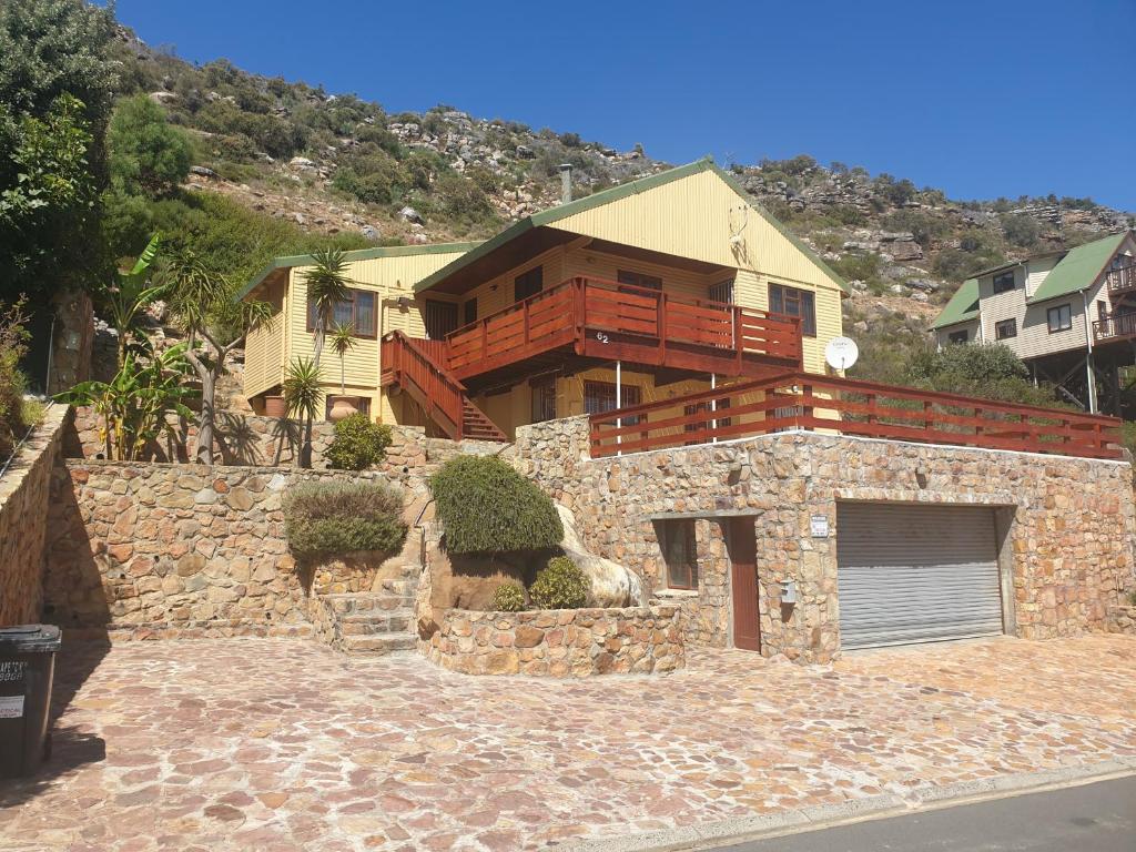 a house on top of a stone wall at Ras Vill in Glencairn