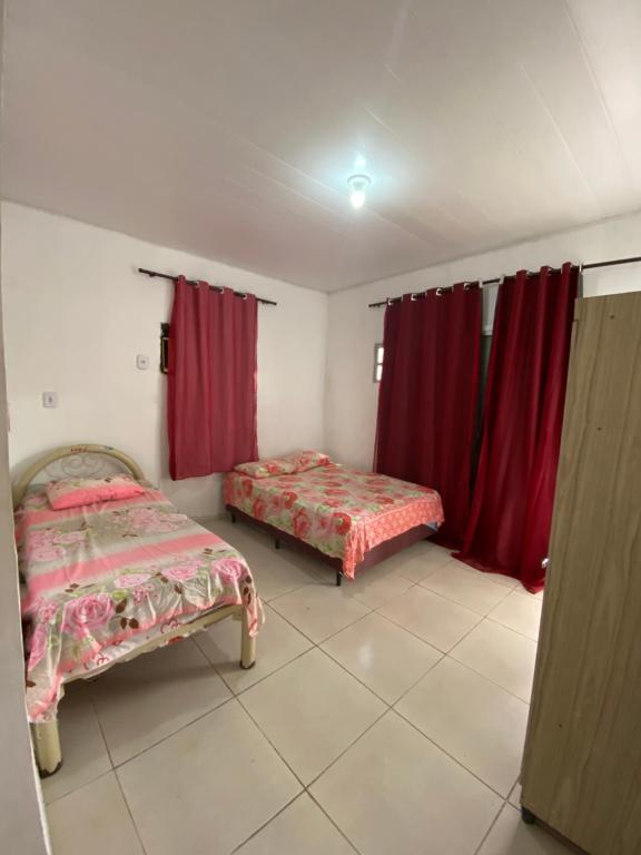 Ένα ή περισσότερα κρεβάτια σε δωμάτιο στο Casa Refugio das Palmeiras