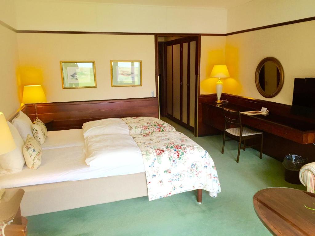 Postel nebo postele na pokoji v ubytování Hotel Hesselet
