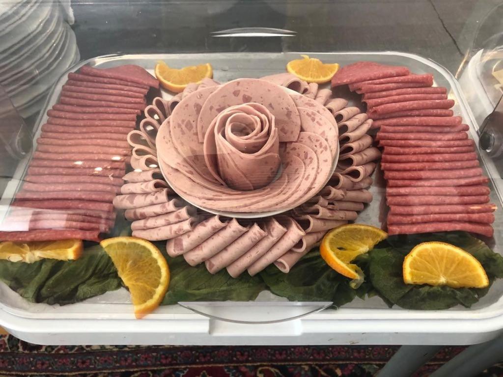 a tray of food with a pink cake on it at HOTEL S Norderstedt in Norderstedt