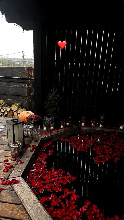 a red balloon is flying over a pool of red roses at Shalash 2 in Velikiye Lazy