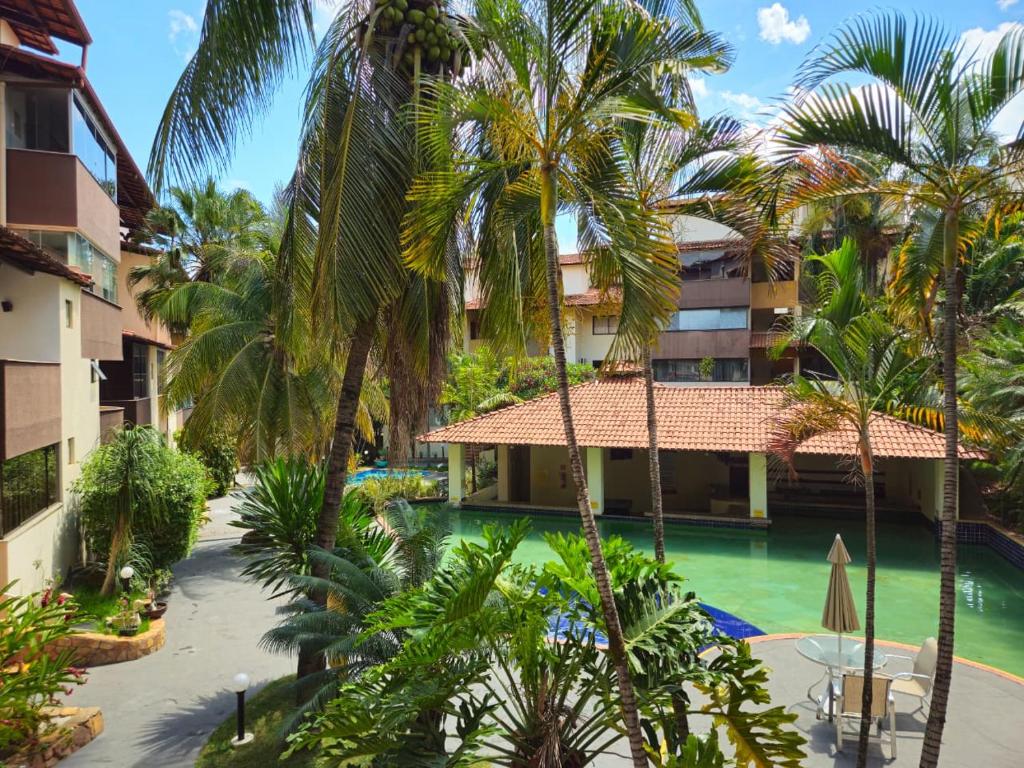 an aerial view of a resort with a pool and palm trees at Apto Residencial Aconchego2 em Rio Quente Go - Hot Park in Rio Quente