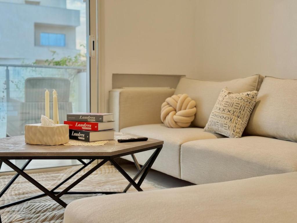 a living room with a couch and a coffee table at Residence The Green in Tunis
