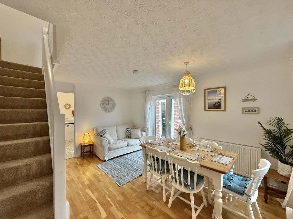 a dining room and living room with a table and chairs at SubLyme in Lyme Regis