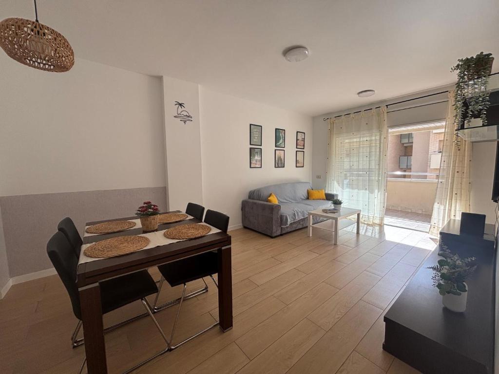 a living room with a table and a couch at Apartamento Clotilde Lloret in Lloret de Mar