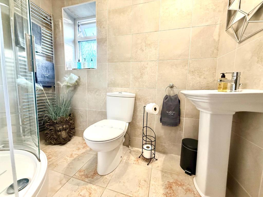 a bathroom with a toilet and a sink and a shower at Wharfe View Cottage Ilkley in Ilkley