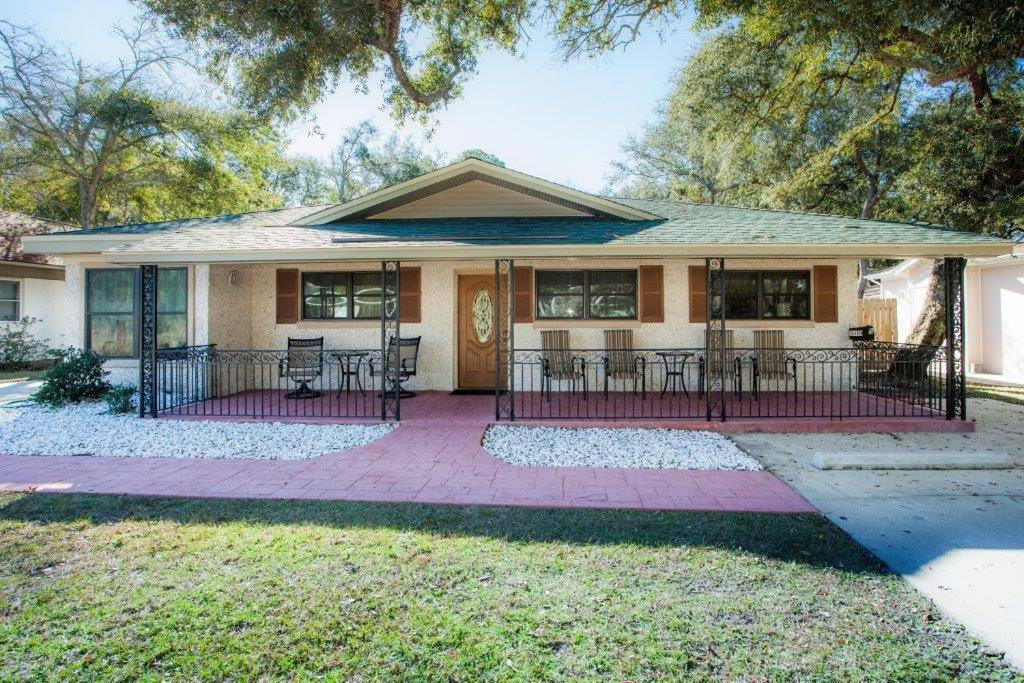 a house with a porch with chairs and tables at Barronhaus in Jekyll Island