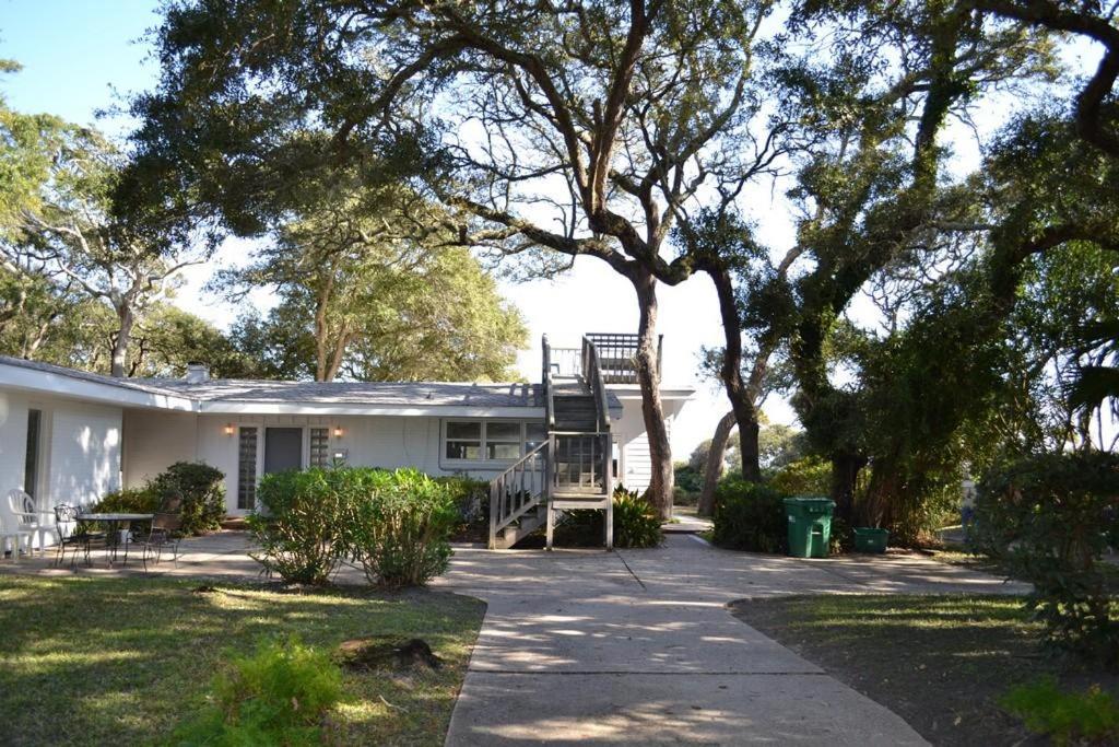 een wit huis met een trap in de tuin bij Cottage By The Sea - Unit A in Jekyll Island