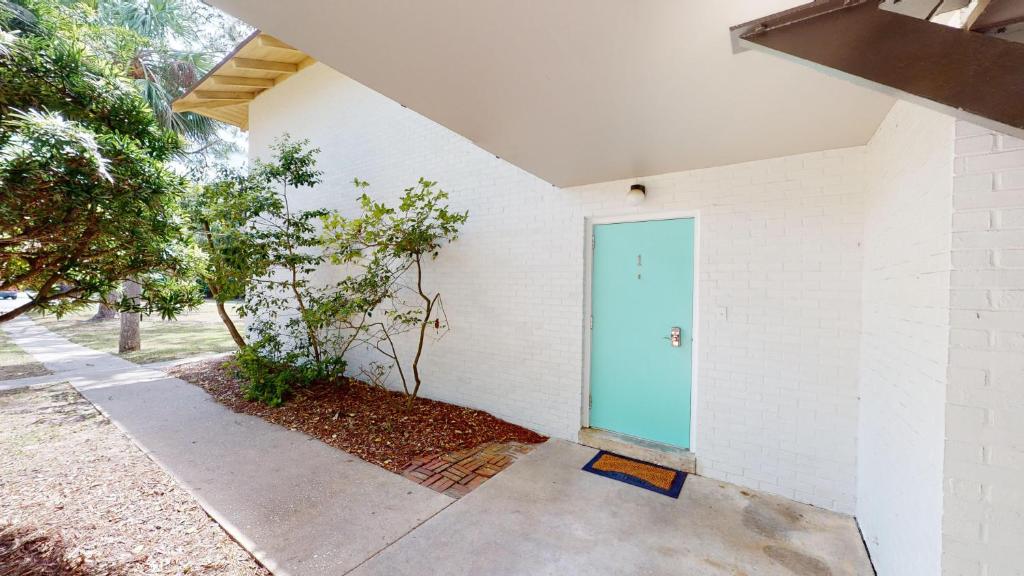 a building with a blue door on the side of it at Atlantic Breeze #1 in Jekyll Island