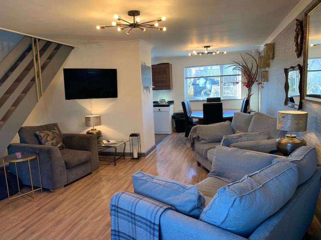 a living room with two couches and a tv at The Maisonette - Central Windermere, with parking in Windermere