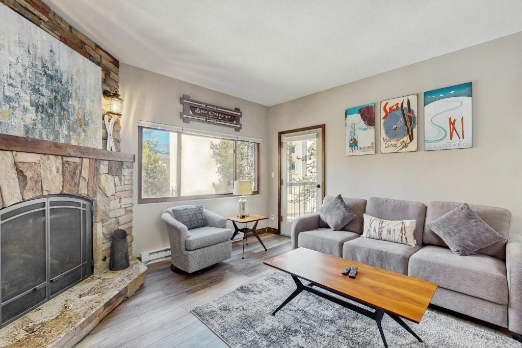 a living room with a couch and a fireplace at Mountainwood 303 in Breckenridge