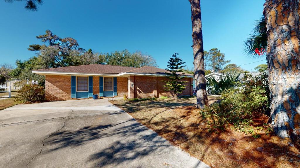 a house with palm trees in front of it at Turtle's Nest Duplex in Jekyll Island